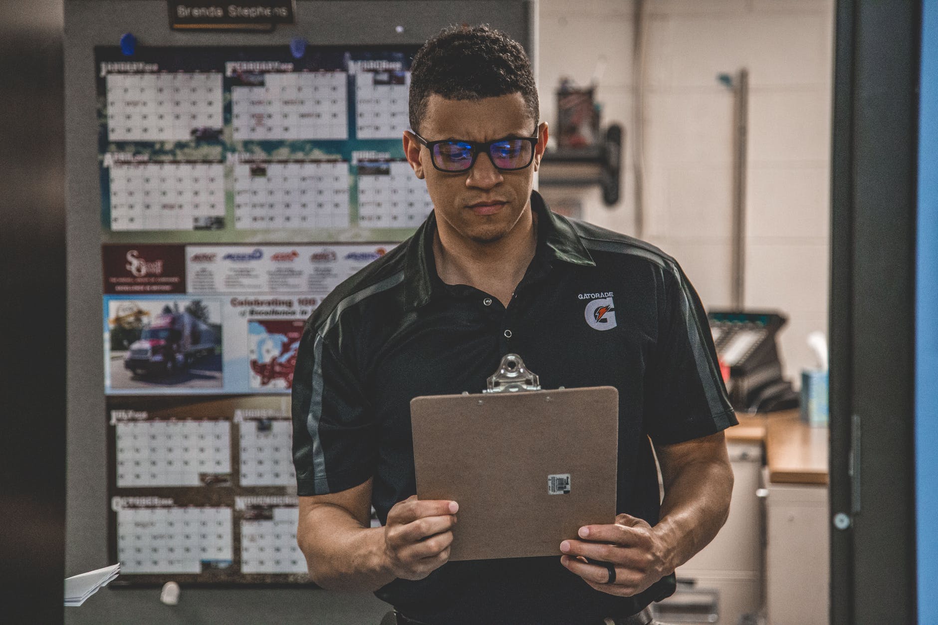 man holding clipboard inside room